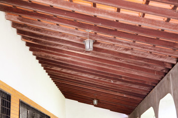 Rustic wooden beams on the roof of an external balcony