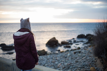 Girl in a husky hat at sunrise