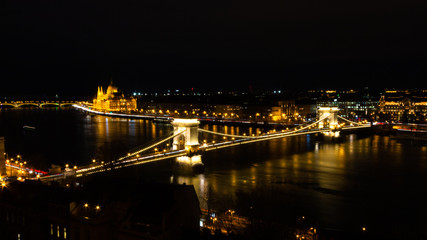 Fototapeta na wymiar views of the European city of Budapest, capital of Hungary, illuminated at night next to the Danube river.