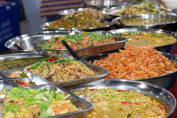 Different thai street food on sale at one of the markets at Bangkok, Thailand. Selective focus