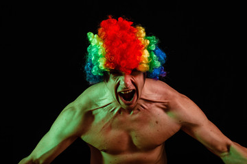 Crazy clown with an ax. Clown with an ax. Crazy. Psycho. Crazy man with an ax on a black background.