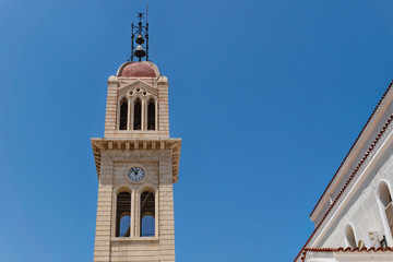 Fototapeta na wymiar Detail of the Megalos Antonios church bell tower on blue cloudless sky in Rethymnon, Crete, Greece