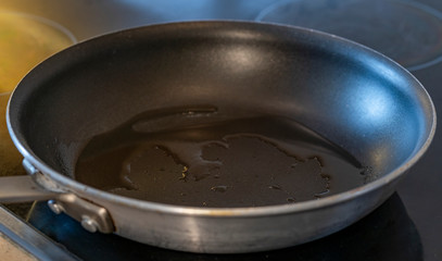 Close up of cooking pan with oil in modern stove