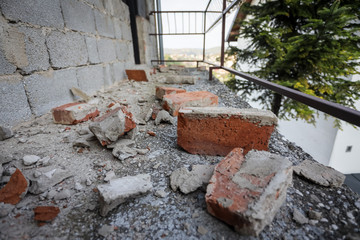 Scattered and damaged bricks on the balcony