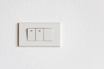 Switch for turning on and lighting the house which is installed on the white wall