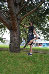 Fototapeta premium white man doing stretching exercises in the park outdoors wearing mask