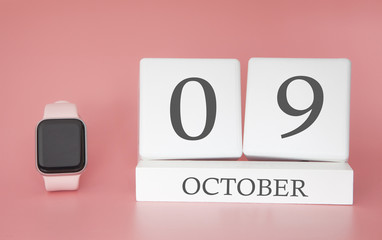 Modern Watch with cube calendar and date 09 october on pink background. Concept autumn time vacation.