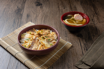 Butadon, Japanese rice bowl dish consisting of bowl of rice topped with pork belly simmered surved with with Japanese oden soup.