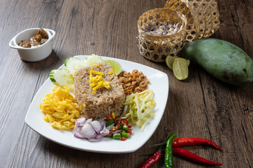 shrimp paste rice with caramelized pork condiment, dried shrimp, green mango, chilies, lime, shallot , cucumber. thai food called kao Kluk Kapi.
