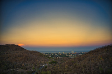 This unique photo shows the autumnal hilly landscape on the Hin lek fai during a sunset! The beautiful golden sky over the city of Hua Hin in the background. The picture was taken with a drone.