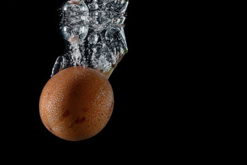 passion fruit entering the water and splashing