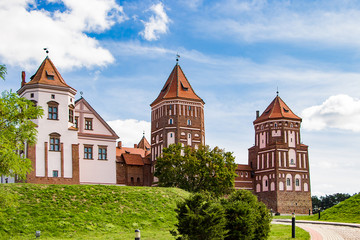 Fototapeta na wymiar Mir, Belarus. Medieval castle on a background of blue sky. Summer panoramic landscape, ancient architecture