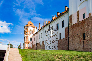 Fototapeta na wymiar Mir, Belarus. Beautiful medieval castle on a background of blue sky. Summer landscape, ancient architecture.