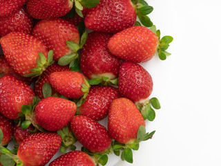 Top view. Copy space. Many strawberries in the white dish and white background.