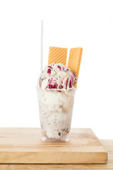 Plastic cup with ice cream; photo on white background.