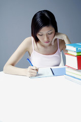 Female student writing on notebook