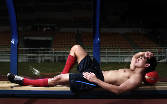 Man Lying Down On The Bench