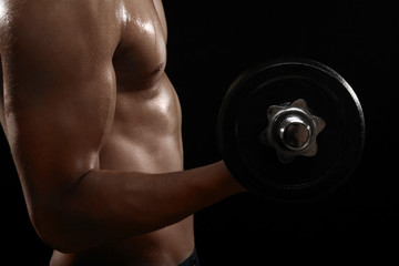 Fototapeta na wymiar Muscular man lifting dumbbell