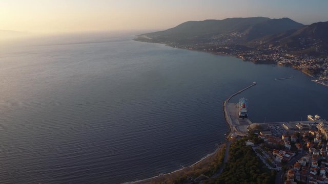 Aerial Golden Sunset Over Sea With Pan Right View Of Port Town Of Lesbos, Greece