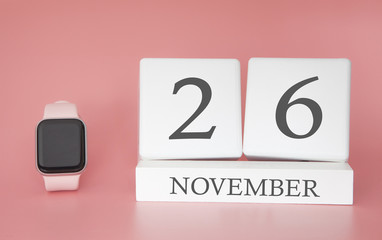 Modern Watch with cube calendar and date 26 november on pink background. Concept autumn time...