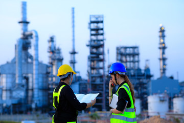 Smart two female engineer discussion together at refinery industry plant at industry factory center...