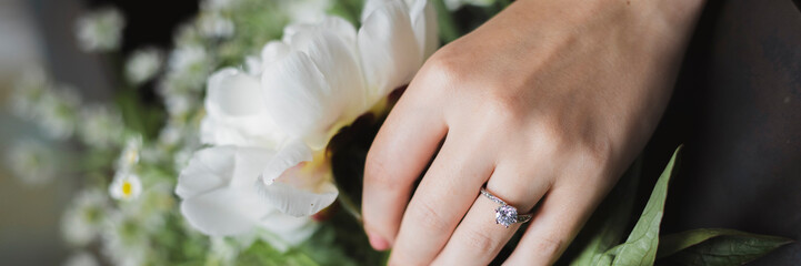 Hand selecting a white flower