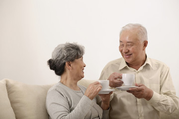 Senior man and woman enjoying tea