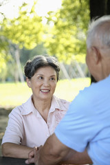 Obraz premium Senior woman smiling at senior man