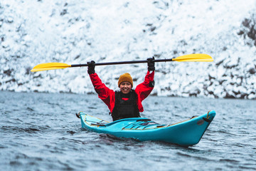 Fototapeta na wymiar Woman paddling a kayak in Lofoten, Norway