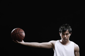 Man holding ball with arm outstretched