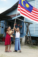 Children holding Malaysian flag