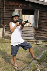 Boy playing with toy rifle