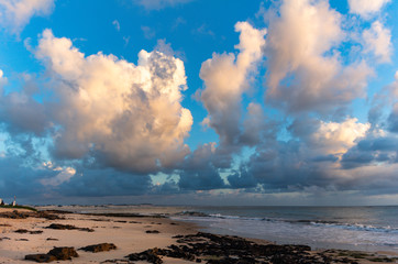 Beautiful cumulus clouds lit by the sunrise sun. Water in gaseous form