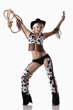 Woman in cowgirl costume holding rope