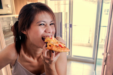 Happy woman eating tasty pizza.