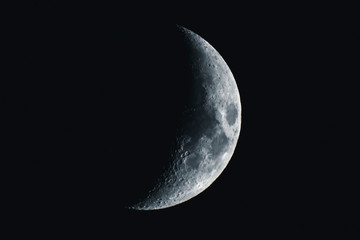 Crescent moon in a black sky - obrazy, fototapety, plakaty