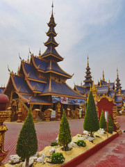 Buddhist temple, blue pagoda with multiple roofs. Northern Thailand.
