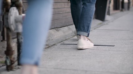 Social distancing. Waiting in a line to enter store during a pandemic. Spaced out lineup during a pandemic. Social distancing in front of a business. Shot in 4k.