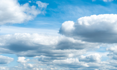 Clouds flying in the blue sky. Huge fluffy clouds background
