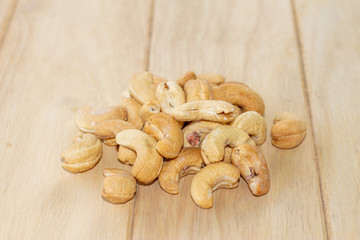 Many Roasted salted cashew nuts  on wooden background