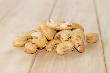 Many Roasted salted cashew nuts  on wooden background