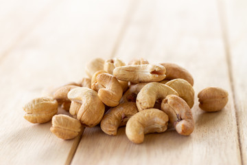 Many Roasted salted cashew nuts  on wooden background