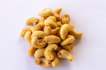 Many Roasted salted cashew nuts  and fly on it isolated on a white background