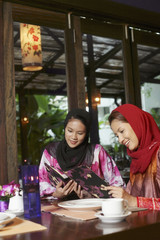 Women reading menu at restaurant