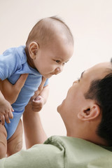 Man playing with baby