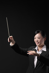 Woman conducting with baton in hand