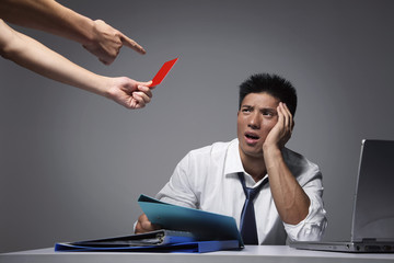 Businessman being given red card