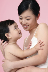 Obraz na płótnie Canvas Woman embracing baby girl