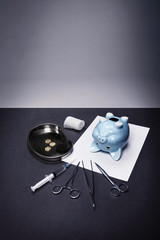Piggy bank with surgical instruments
