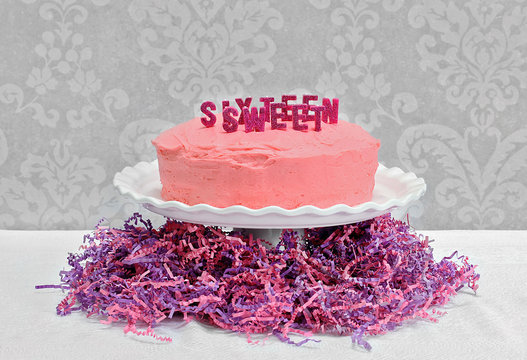 Pink Layer cake with Sweet Sixteen spelled out.